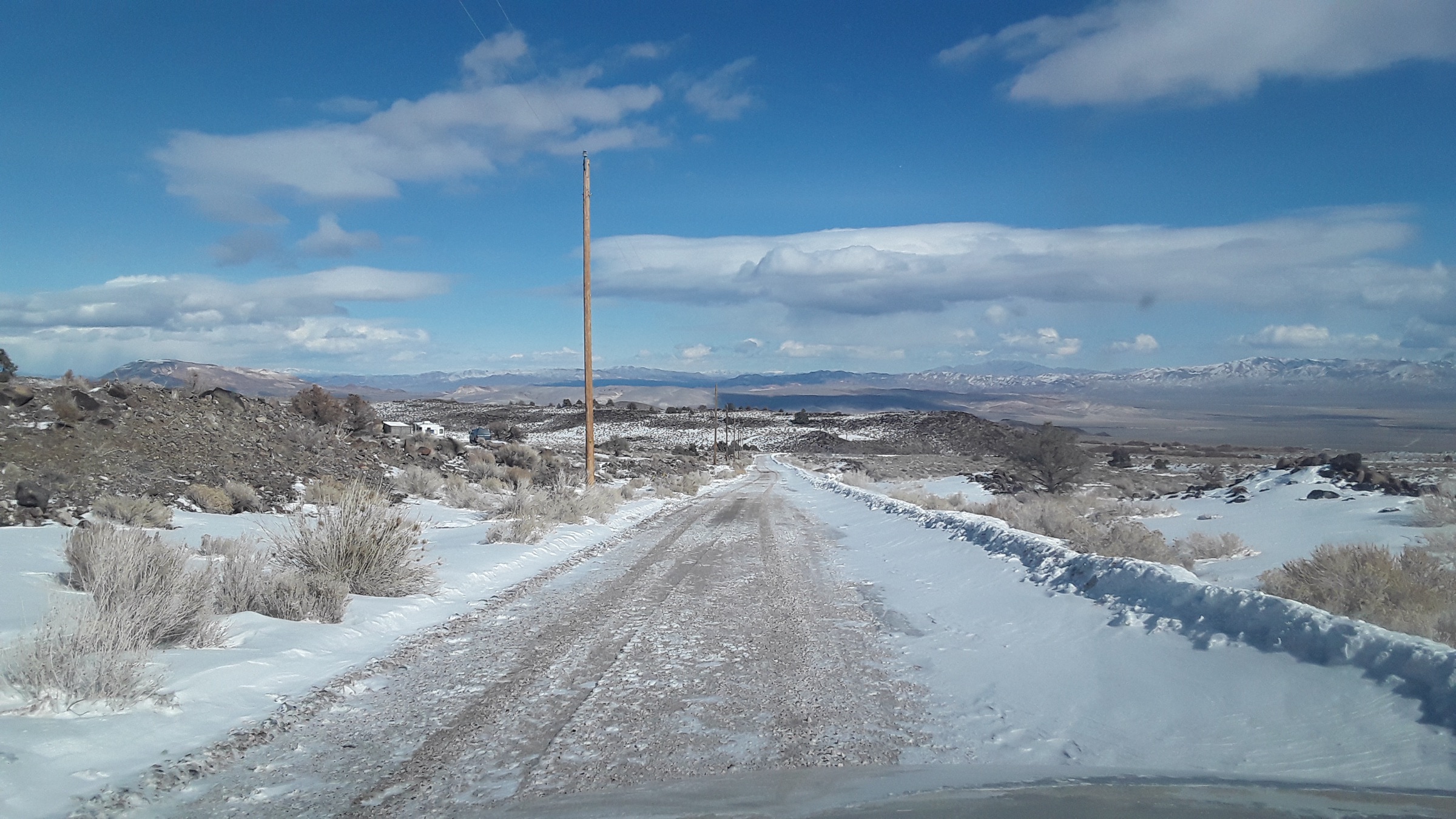 Road view looking northeast with the property on the left